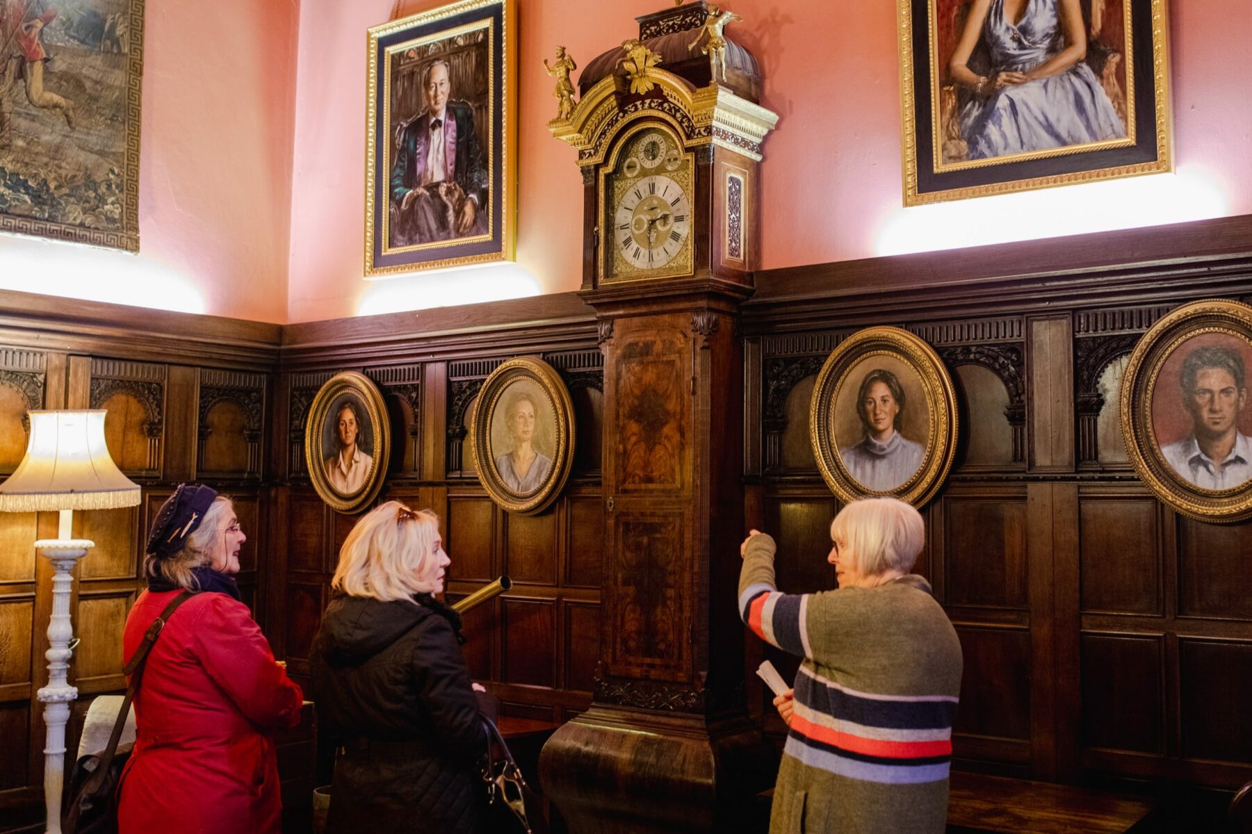 Three women explore a room at Powderham Castle
